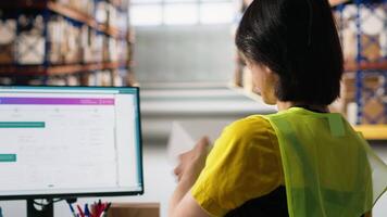 Male staff member does inventory check and registering parcels, reviewing shipping labels and tracking info on package tracking software. Managing e-commerce retail operations. Camera B. video