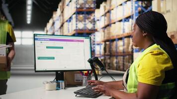 Staff member managing barcodes awb scanning tasks for online shopping orders, merchandise with shipping labels and details for easy delivery. Fulfillment center employee. Camera A. video