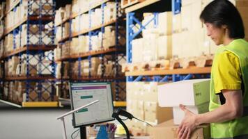 Warehouse worker scanning airway bills labels applied on cargo packages, monitoring shipping route on package tracking software. Registering the details for the logistics. Camera A. video