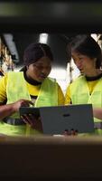 Vertical Large business employees managing online shopping orders surrounded by huge racks with cargo boxes, import export delivery system. Fulfillment center supports product handling. Camera A. video