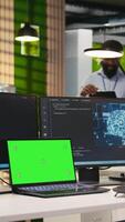 Vertical Admin in office using isolated screen laptop, automating repetitive tasks with AI scripts. IT expert using artificial intelligence on chroma key device to speed up feature implementation, camera A video