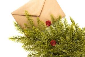 Fake fir tree branch with craft envelope for decorating of bouquets and home photo