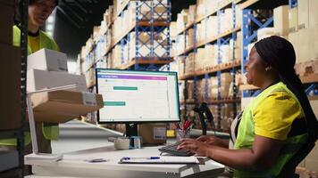 Black employee scanning awb tags after packaging operations in a distribution center, using a scanner to register barcode shipping labels for future order tracking. Storage room. Camera A. video