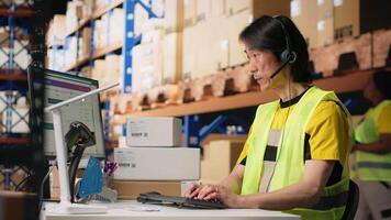 Call center employee assisting customers in a fulfillment center, handling inventory control and package tracking. Asian man resolving issues related to delivery delays or wrong addresses. Camera B. video