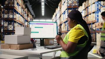 Woman staff managing package labeling using shipment details adhesive tags, handling order processing and preparing the packages for distribution. Online shopping fulfillment center. Camera A. video