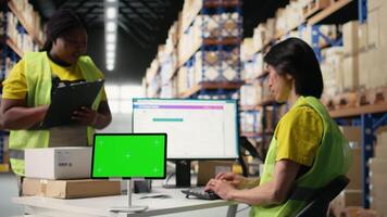 African American employee uses a isolated mockup screen on computer, business software used for supply chain system and package tracking service. Real-time order fulfillment displays. Camera A. video