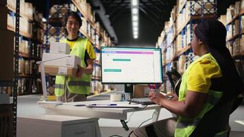 Female warehouse clerk registering barcodes for packages, scanning the shipping labels and awb tags on cardboard boxes. Fulfillment center distribution operations for e-commerce. Camera A. video