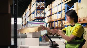 Asian male staff uses handheld scanner to register airway bill information, updating the package tracking software in real time with barcode reader and shipment details. Stock room. Camera A. video