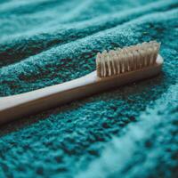 A toothbrush laying on a towel photo
