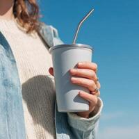Person holding creative tumbler in bright setting photo