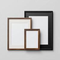 Three empty wooden frames on a white wall photo