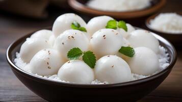 Mochi balls in a bowl with rice and mint leaves. photo