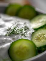 Close Up of Creamy Tzatziki Dip with Fresh Cucumber and Dill. photo