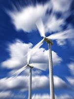 Dynamic Wind Turbines Against a Blurred Sky. A captivating image showcasing the power and movement of renewable energy. photo