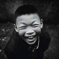 Close Up of a Boy's Joyful Laugh Black and White Portrait. photo