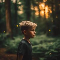 Boy Contemplating Nature in a Forest at Sunset. A thoughtful young boy stands in a lush forest, illuminated by the warm glow of the setting sun. photo