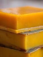 Close up of Stacked Blocks of Golden Yellow Beeswax. photo
