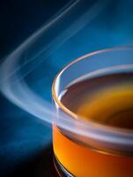 Abstract Image of Orange Liquid in a Glass Dish with Smoke Trails. photo