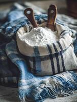 Flour in a Rustic Burlap Sack with Wooden Spoons. A close up image of baking ingredients. photo