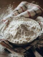 Close Up of a Bowl of Flour on a Rustic Table. A Pile of White Flour Sits in a Metal Bowl, Ready for Baking. photo