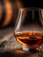 Close up of amber liquid in a crystal glass on a wooden surface. A sophisticated image perfect for beverage advertising. photo