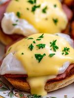 Close Up of Eggs Benedict with Hollandaise Sauce and Ham. A delicious breakfast or brunch food photography image. photo