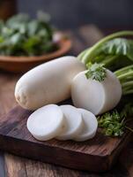 Fresh White Radishes on Rustic Wooden Board Close up of Sliced and Whole Radishes with Greens. photo