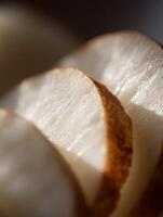 Close up of Sliced Raw Jicama, Showing Textural Details and Subtle Brown Edges. photo