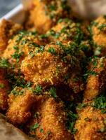 Close up of Crispy Fried Food with Fresh Herbs. Golden brown, delicious-looking food, perfect for restaurant menus or food blogs. photo