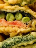 Close up of Crispy Fried Vegetable Tempura, showcasing Peas and Carrot. photo