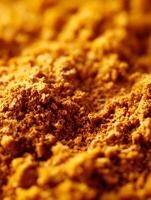 Close up of Aromatic Turmeric Powder Texture, Golden Spice Background. photo