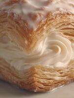 Close Up of Flaky Pastry with Creamy Filling and Icing. A Detailed Image of a Delicious Dessert. photo