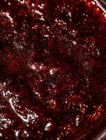 Close up of Red Glitter with Golden Sparkle. A Detailed Macro Shot of Shimmering Texture. photo