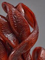 Abstract Close Up of Intertwined Red Forms with Textured Surface. photo
