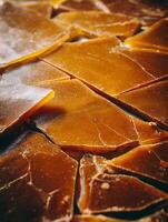Close up of amber colored resin pieces, illuminated with warm light. photo