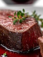 Close up of a Delicious Seared Steak with Red Wine Reduction and Thyme. photo
