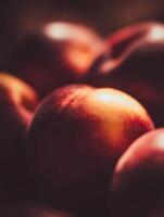 A Close Up of Ripe Nectarines, Illuminated by Warm Light. photo