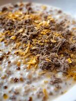 Close Up of Creamy Porridge with Meat and Crispy Topping. photo