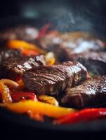 Close Up of Sizzling Steak and Peppers. A delicious image perfect for menus, cookbooks, or culinary websites. photo