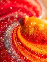 resumen arremolinándose rojo y oro Brillantina textura un cerca arriba de reluciente partículas foto