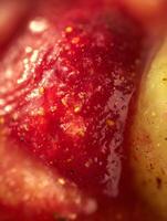 Extreme close up of strawberry and apple texture, vibrant red and yellow colors. photo