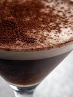 Close up of a delicious chocolate coffee drink, topped with cocoa powder. A tempting beverage perfect for a cafe menu or culinary blog. photo