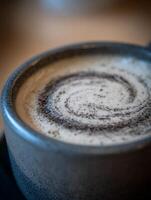 Close up of a Swirled Cappuccino in a Gray Mug. photo