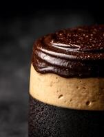Close up of a Delicious Three Layered Chocolate Cake with Creamy Filling and Ganache Topping. photo