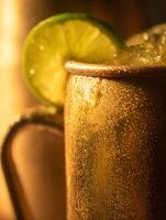 Close up of a Refreshing Moscow Mule Cocktail in a Copper Mug. photo
