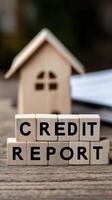 Model house and credit report letters emphasize financial health and housing decisions photo