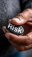Close up of hand twisting risk button with circular gauge for decision making photo