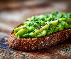 Avocado toast with thyme and salt on a wooden surface photo