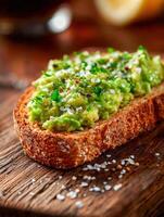 Avocado toast garnished with sea salt and parsley on wood photo