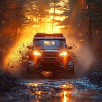 Adventurous off road vehicle splashes through mud at sunset in a forested terrain photo
